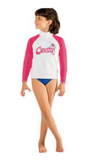 Child wearing a pink and white long-sleeve rash guard with blue shorts on a white background