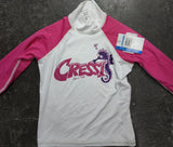 Kid's rash guard with long sleeves, primarily white with pink sleeves and a graphic logo on the front.